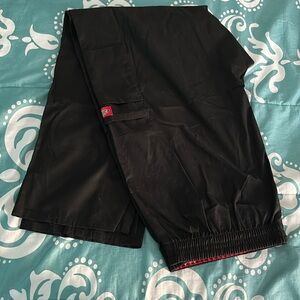 Two long black dickies pants. Never worn. Pockets on each side.